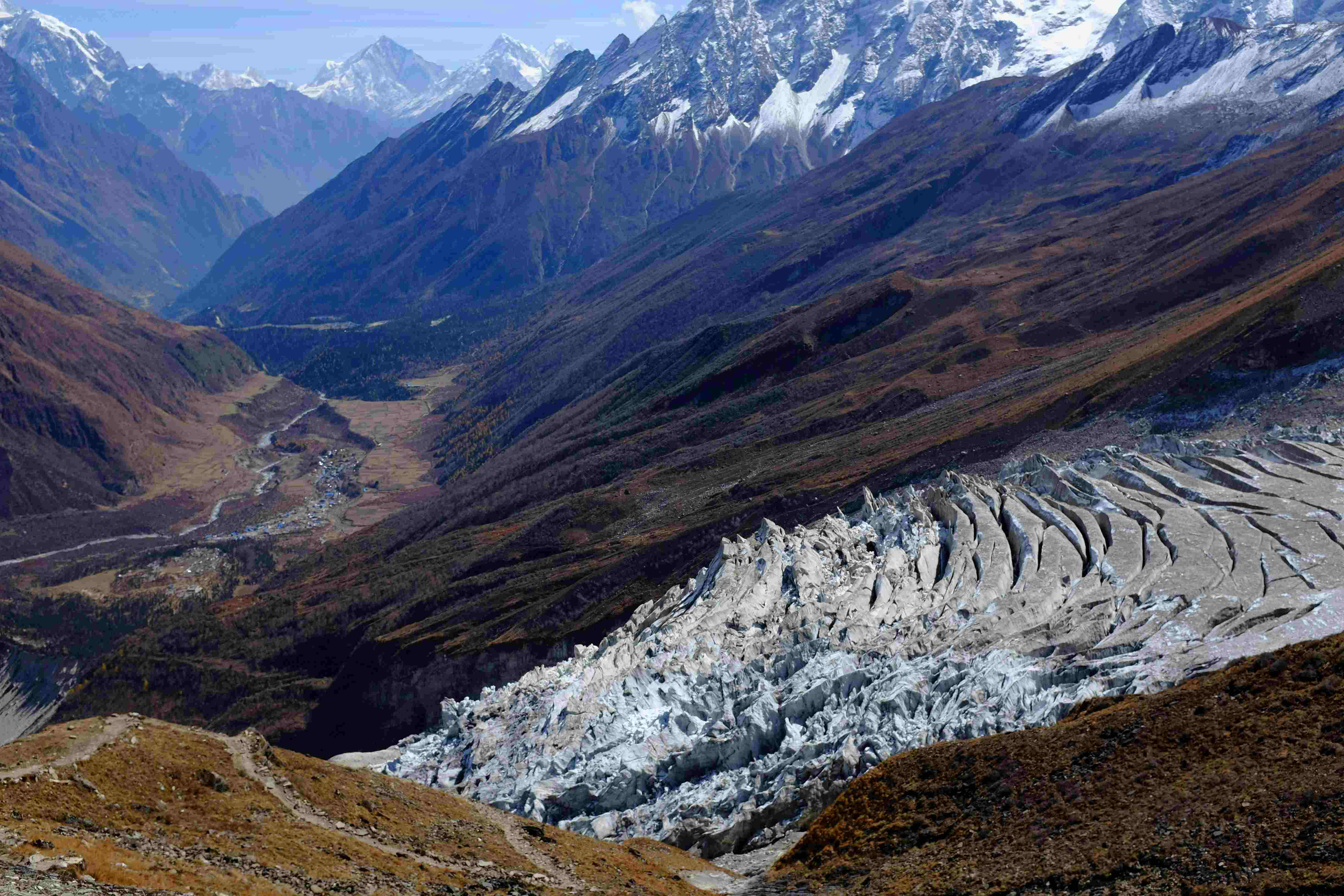Breathtaking aerial view of a massive glacier and deep valley on the Manaslu Circuit Trek in Nepal.