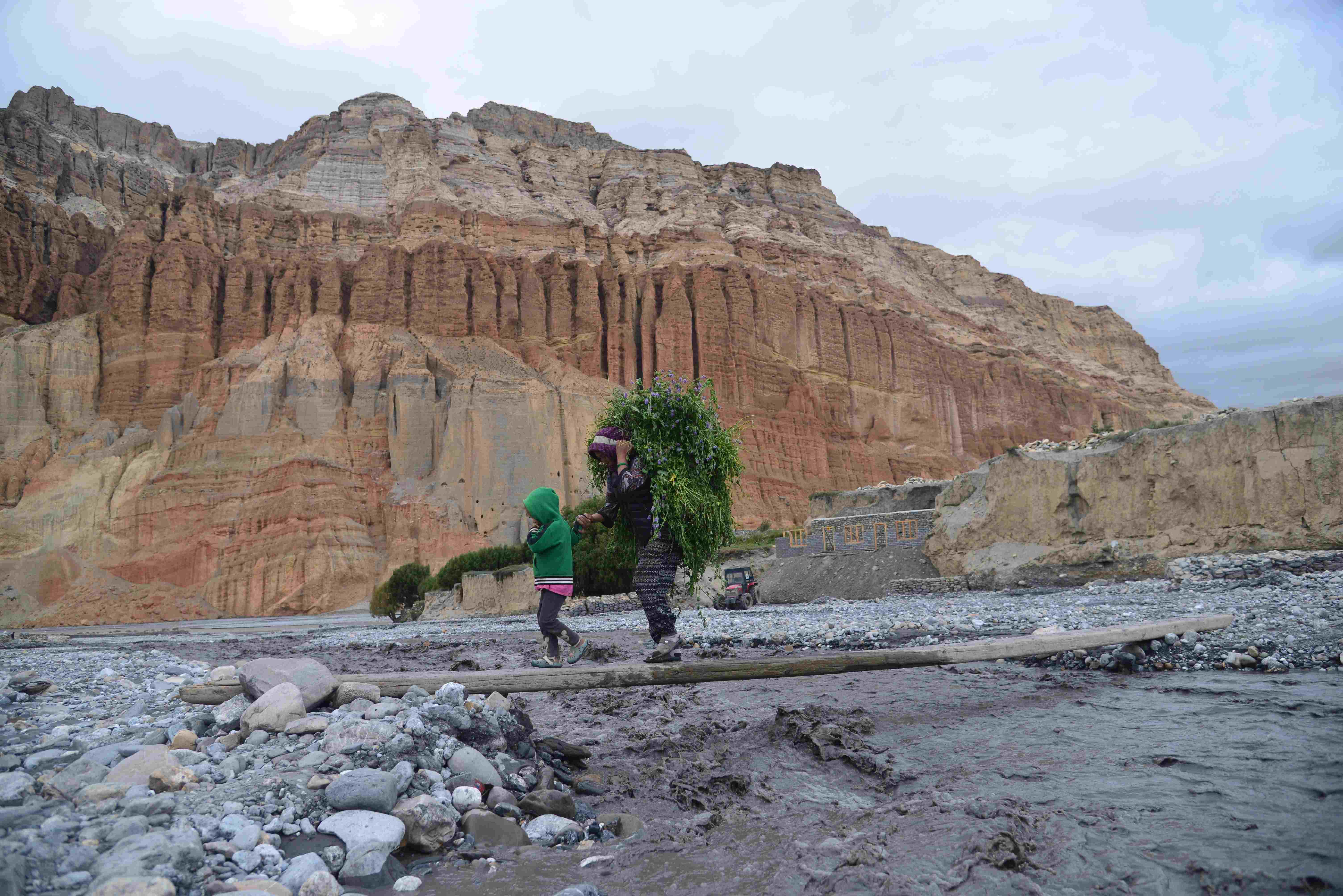 Local villagers crossing a mountain stream in Upper Mustang, Nepal