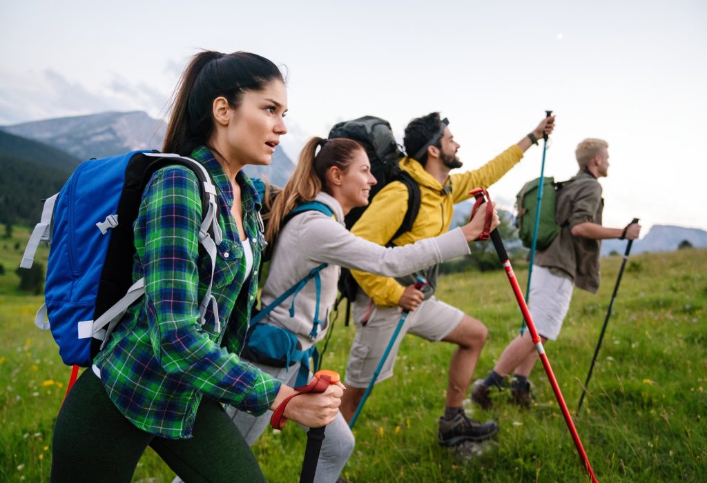 group-of-friends-trekking-with-backpacks-walking-in-the-forest-1.jpg